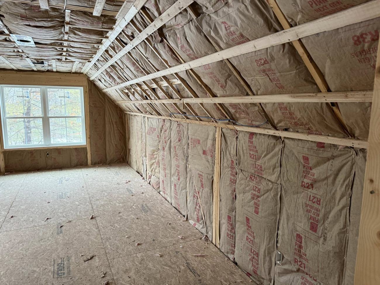Owens Corning PINK Next Gen R-21 and R-38 fiberglass batts installed in an attic knee wall and roof slope